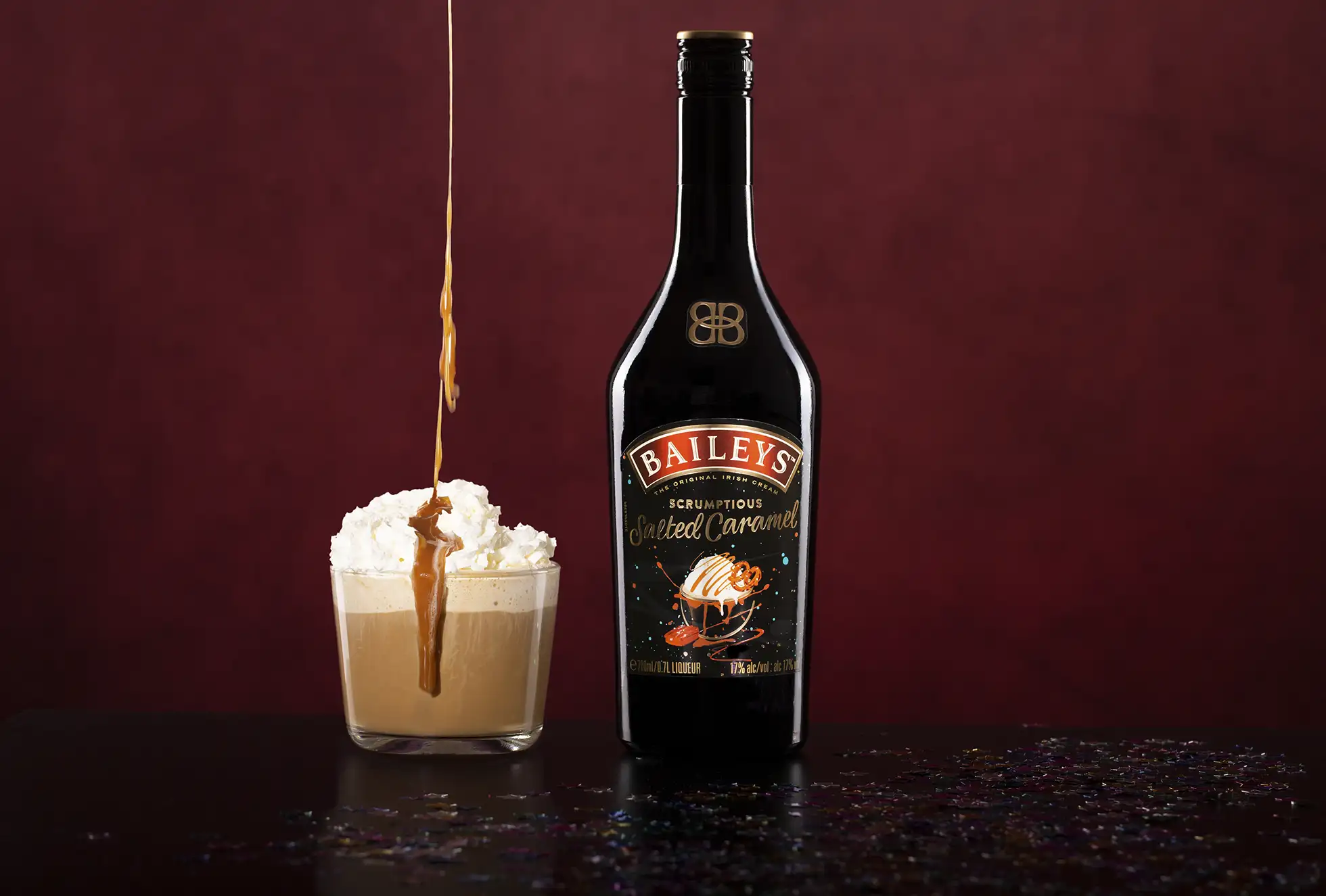 A bottle of Bailey's Salted Caramel with mixed drink cocktail